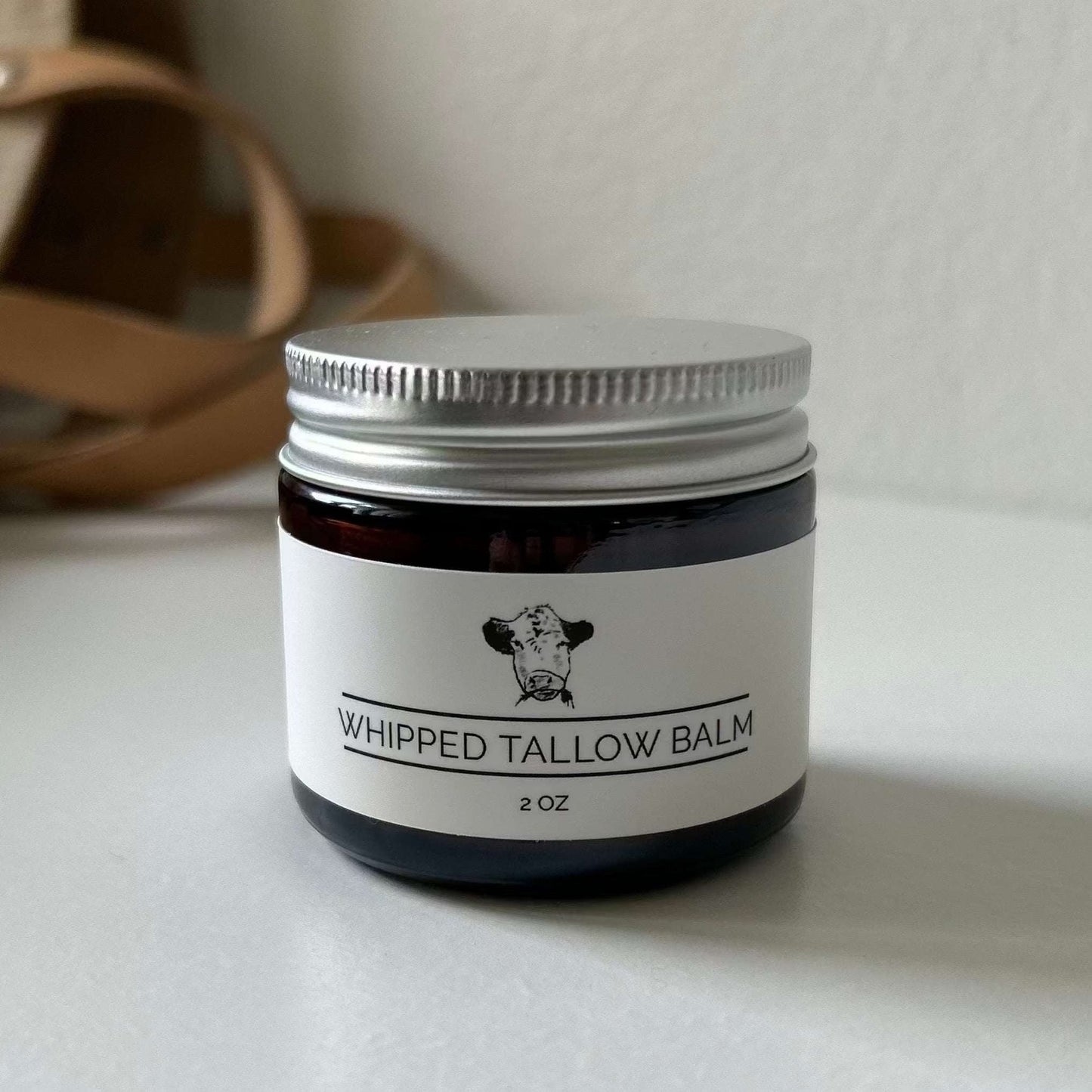 Whipped Tallow Balm jar with natural moisturizing ingredients and masculine scent elements