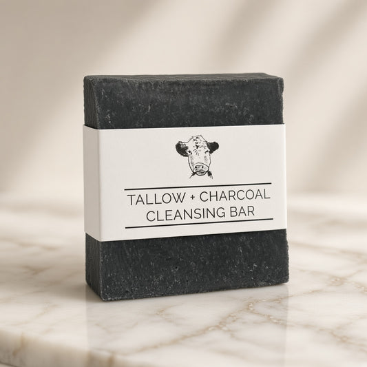 Tallow + Charcoal Cleansing Bar on marble, angled view
