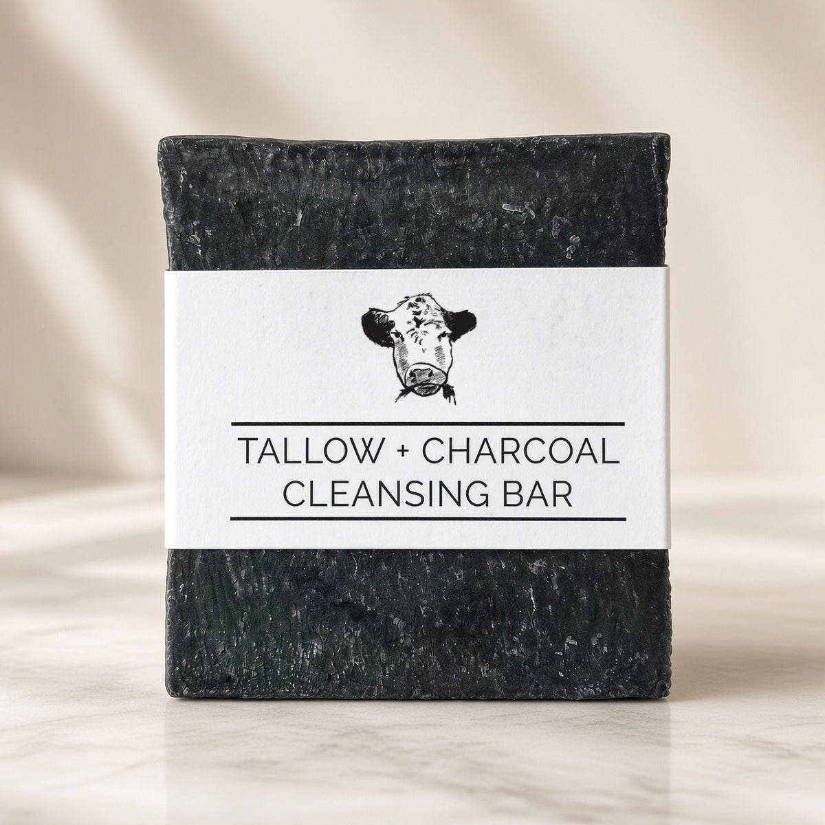 Tallow + Charcoal Cleansing Bar, a charcoal tallow soap made with grass-fed beef tallow, front label