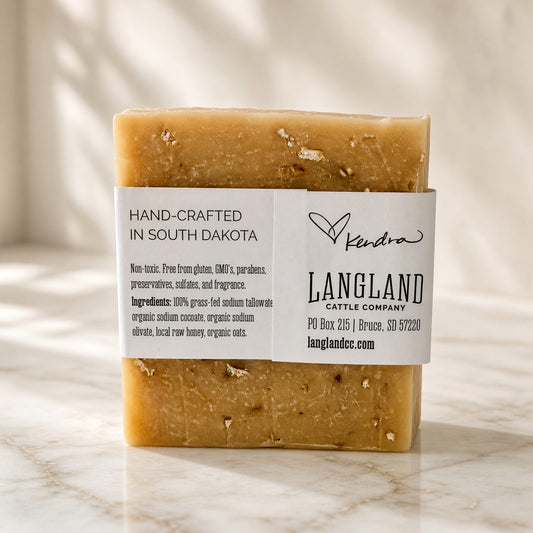 Back label of Tallow + Honey Oat Cleansing Bar listing grass-fed tallow, organic coconut and olive oils, local raw honey and organic oats