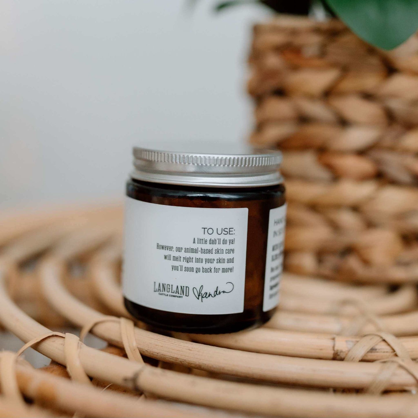 Jar of Whipped Tallow Balm with lavender and mint on woven surface