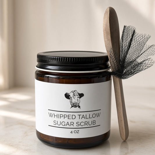 Whipped tallow sugar scrub made with grass-fed beef tallow in a 4 oz amber jar with a wooden spoon